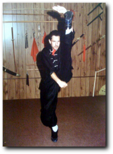 Shifu Jack performing a high kick, black and white photo
